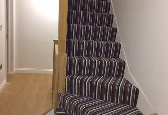 Stripe carpet fitting job on stairs