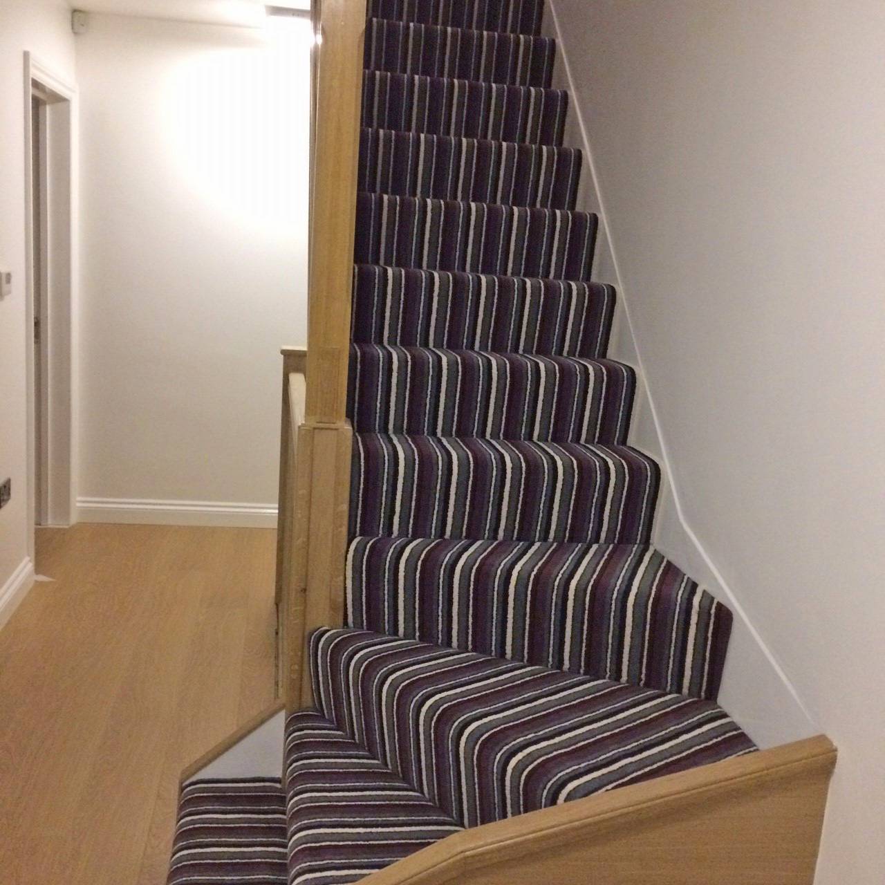 Stripe carpet fitting job on stairs