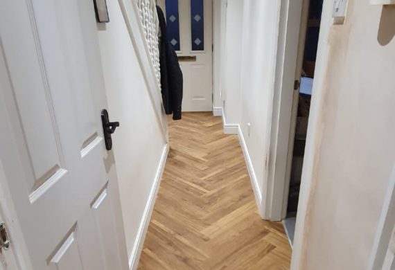 Herringbone style wooden floor in a hallway