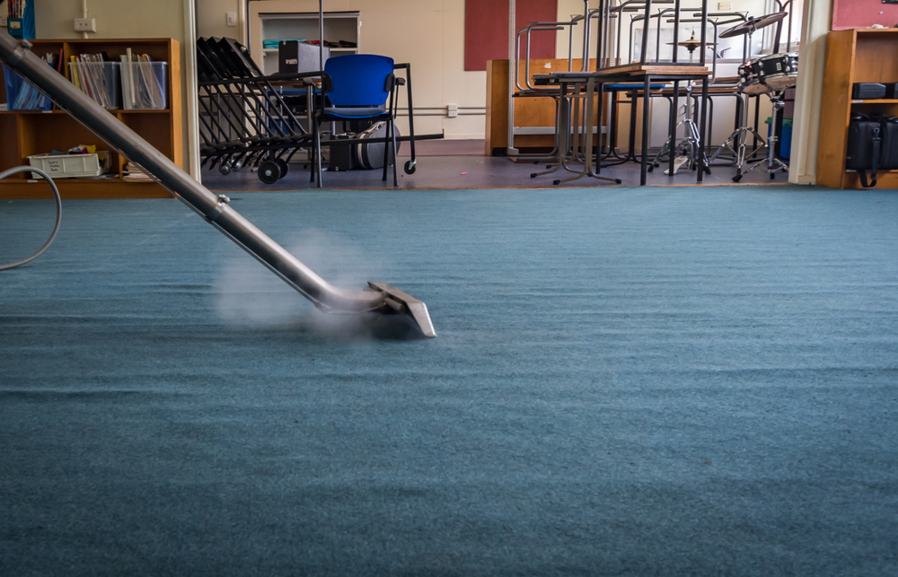 Someone steam cleaning the carpet