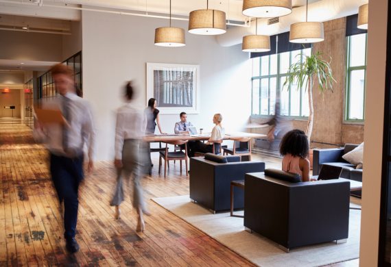 A busy office with a wooden flooring