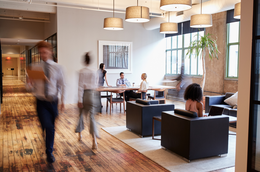 A busy office with a wooden flooring